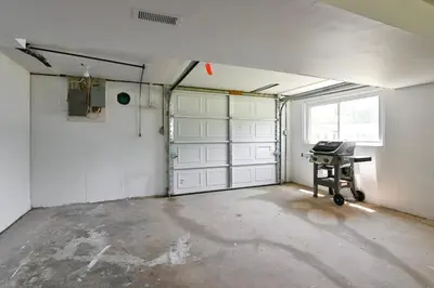 a garage with white doors and a desk in it at 3BR Home for 8 - Only 5 Minutes to Ark - Foosball in Williamstown