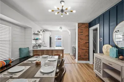 a dining room and kitchen with a table and chairs at Amazing Parma Home King Bed Full Office Room in Parma