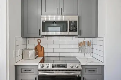 a kitchen with a stove and a microwave at Amazing Parma Home King Bed Full Office Room in Parma