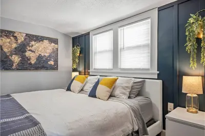 a bedroom with a bed and two windows at Amazing Parma Home King Bed Full Office Room in Parma
