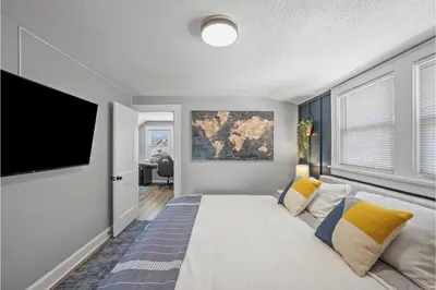a bedroom with a large bed and a flat screen tv at Amazing Parma Home King Bed Full Office Room in Parma