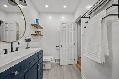 a bathroom with a sink and a mirror and a toilet at Amazing Parma Home King Bed Full Office Room in Parma