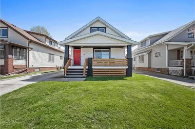 a house with a red door and a yard at Amazing Parma Home King Bed Full Office Room in Parma
