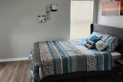 a bedroom with a bed with a quilt and pillows at Beautiful 4 bedroom in Cleveland in Euclid