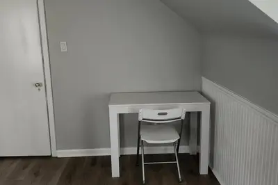 a white desk with a chair in a room at Beautiful 4 bedroom in Cleveland in Euclid