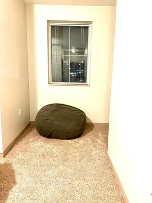 a room with a bean bag chair in front of a window at The KING Apt in Downtown Columbus in Columbus