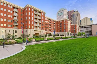 a park in front of a building with tall buildings at King & Queen in Downtown Columbus in Columbus