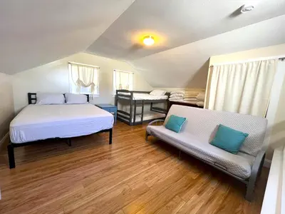 a bedroom with two beds and a couch at Beautiful Boathouse overlooking the Bay in Sandusky