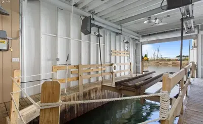 a wooden dock with a pool of water in a building at Beautiful Boathouse overlooking the Bay in Sandusky