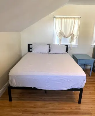 a bedroom with a large bed with a window at Beautiful Boathouse overlooking the Bay in Sandusky