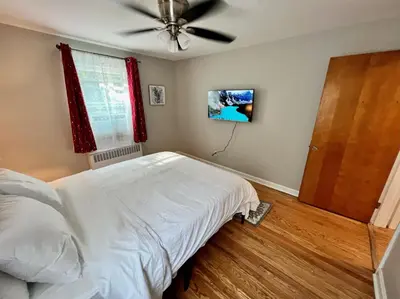 a bedroom with a bed and a ceiling fan at Red Ruby Spacious 2 Bedroom Apt 10 Minutes to Dwntwn in Cincinnati