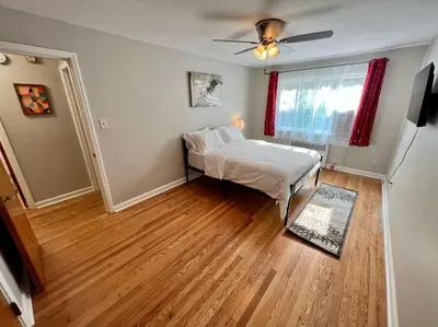 a bedroom with a bed and a ceiling fan at Red Ruby Spacious 2 Bedroom Apt 10 Minutes to Dwntwn in Cincinnati