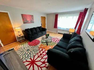 a living room with a couch and a table at Red Ruby Spacious 2 Bedroom Apt 10 Minutes to Dwntwn in Cincinnati