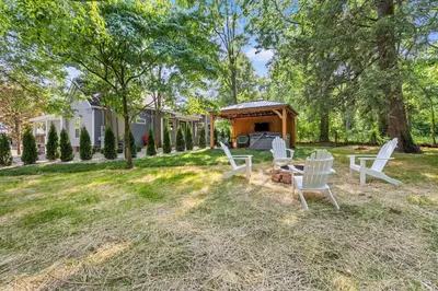a group of white chairs and a gazebo in a yard at The Luxe/Hot Tub/12min to Horse Park/30 Min to Ark in Georgetown