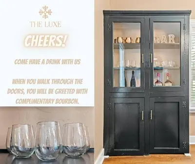 a black cabinet with wine glasses on a table at The Luxe/Hot Tub/12min to Horse Park/30 Min to Ark in Georgetown