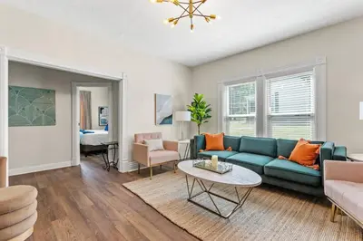 a living room with a blue couch and a table at The Luxe/Hot Tub/12min to Horse Park/30 Min to Ark in Georgetown