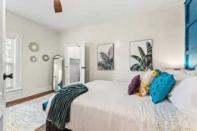 a bedroom with two beds and a mirror at The Luxe/Hot Tub/12min to Horse Park/30 Min to Ark in Georgetown