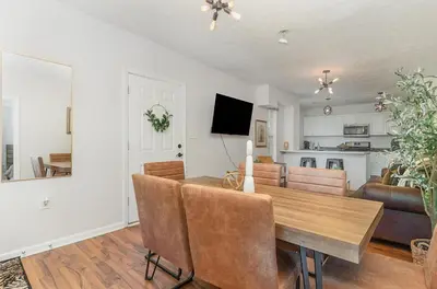a dining room and living room with a table and chairs at Amazing Downtown Views - 3 Minutes to Downtown! in Cincinnati