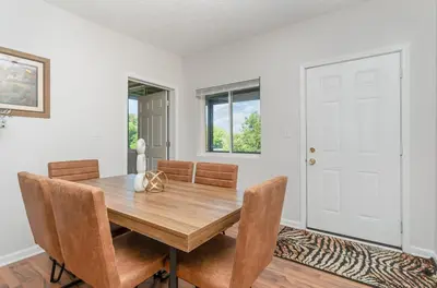 a dining room with a wooden table and chairs at Amazing Downtown Views - 3 Minutes to Downtown! in Cincinnati