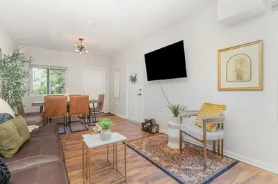a living room with a couch and a table at Amazing Downtown Views - 3 Minutes to Downtown! in Cincinnati