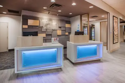 an office lobby with two counters with blue screens at Holiday Inn Express & Suites Dry Ridge by IHG in Dry Ridge