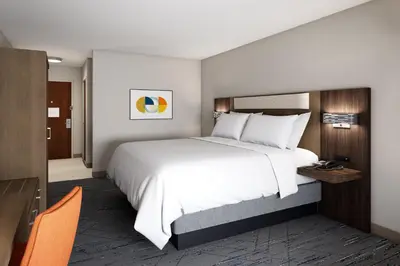 a hotel room with a large bed and a desk at Holiday Inn Express & Suites Dry Ridge by IHG in Dry Ridge