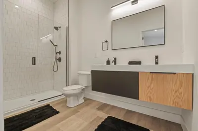 a bathroom with a sink and a toilet and a mirror at Chic Retreats in Columbus in Columbus