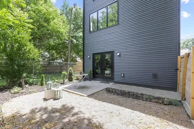 a house with the door open in a yard at Chic Retreats in Columbus in Columbus