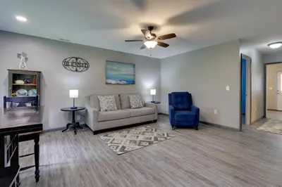 a living room with a couch and a blue chair at Zanesville Vacation Rental 2 Mi to Downtown! in Zanesville