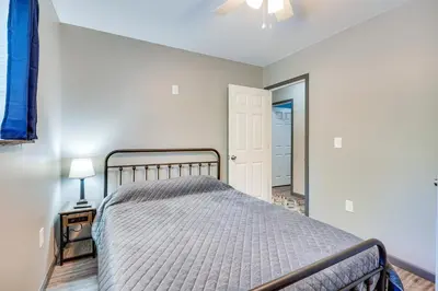 a bedroom with a bed and a lamp on a table at Zanesville Vacation Rental 2 Mi to Downtown! in Zanesville