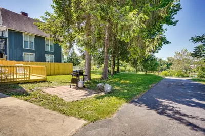 a house with a grill and trees in the yard at Zanesville Vacation Rental 2 Mi to Downtown! in Zanesville