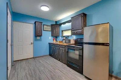 a kitchen with blue walls and a stainless steel refrigerator at Zanesville Vacation Rental 2 Mi to Downtown! in Zanesville