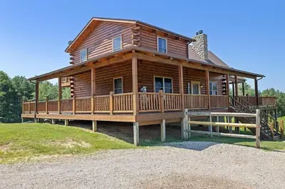 a large wooden house with a large deck at The Lookout in Logan
