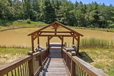a wooden bridge over a body of water at The Lookout in Logan