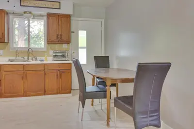 a kitchen with a dining room table and chairs at Cozy Youngstown Apartment with Central AandC and Heating in Youngstown