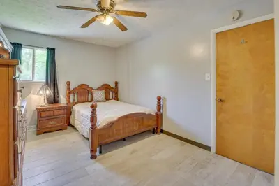 a bedroom with a bed and a ceiling fan at Cozy Youngstown Apartment with Central AandC and Heating in Youngstown