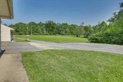 a driveway leading to a field of green grass at Cozy Youngstown Apartment with Central AandC and Heating in Youngstown