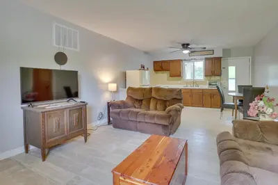 a living room with two couches and a kitchen at Cozy Youngstown Apartment with Central AandC and Heating in Youngstown