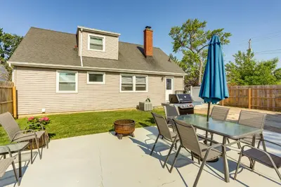 a patio with a table and chairs and an umbrella at Dog-Friendly Port Clinton Home Walk to Lake Erie! in Port Clinton