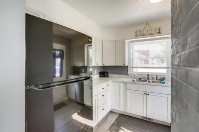 a kitchen with white cabinets and a sink at Dog-Friendly Port Clinton Home Walk to Lake Erie! in Port Clinton