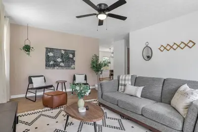 a living room with a couch and a ceiling fan at Housepitality - Electric Ave - 3 BDR and Hot Tub in Westerville
