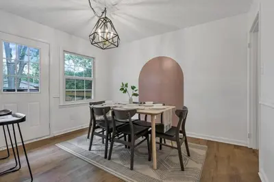 a dining room with a table and chairs at Housepitality - Electric Ave - 3 BDR and Hot Tub in Westerville