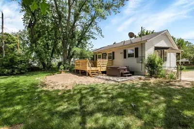 a small house with a patio and a grill at Housepitality - Electric Ave - 3 BDR and Hot Tub in Westerville
