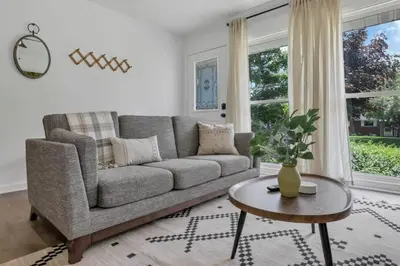 a living room with a couch and a table at Housepitality - Electric Ave - 3 BDR and Hot Tub in Westerville