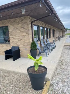 a group of chairs sitting on a patio with a plant at The Hemlock Inn in Loudonville