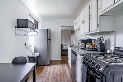 a kitchen with a stove and a refrigerator at Jungle House Columbus Downtown Free Parking Sleeps 6 - Steps to Convention Center & Nationwide Arena - 1BR Short North Luxury Home - Over 5,800 Five Star Stays in Columbus