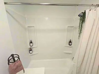 a white bathroom with a tub and a shower at Jungle House Columbus Downtown Free Parking Sleeps 6 - Steps to Convention Center & Nationwide Arena - 1BR Short North Luxury Home - Over 5,800 Five Star Stays in Columbus