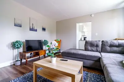 a living room with a couch and a table at Jungle House Columbus Downtown Free Parking Sleeps 6 - Steps to Convention Center & Nationwide Arena - 1BR Short North Luxury Home - Over 5,800 Five Star Stays in Columbus
