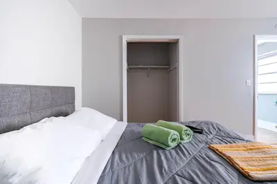 a bedroom with a bed with a green towel on it at Jungle House Luxury Stays - Columbus Downtown Short North in Columbus