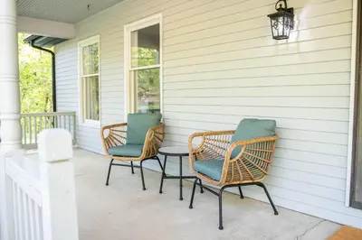 two wicker chairs and a table on a porch at Hunter's Cove in Morehead